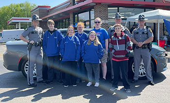 Special Olympics Kentucky athletes join Kentucky State Police Troopers at the 2022 Cover the Cruiser stop in Bowling Green.