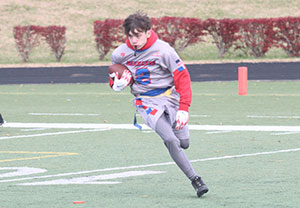 Marshall county flag football player runs with the ball at the 2021 State Flag Football Tournament