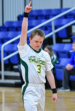 Special Olympics basketball player raises one finger over his head in a Number 1 sign.