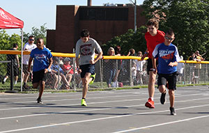 Three young athletes break from the starting line at the State Track Meet