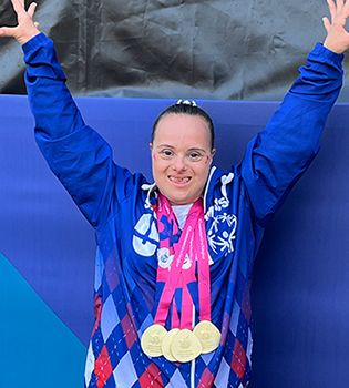 Lee Dockins poses with the four gold medals she won today around her neck.