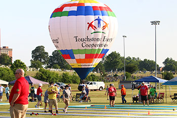 A hot air balloon with a Kentucky's Touchstone Energy Cooperatives logo sits above the bocce courts at the State Summer Games.