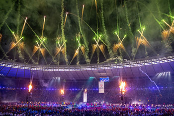 Wide shot of the inside of Berlin's Olympic Stadium during the Opening Ceremony of the Special Olympics World Summer Games. The Special Olympics Cauldron can be seen lit low and on the right side of the photo.
