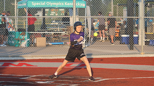 A batter keeps her eye on the ball as she starts to swing at the 2024 State Softball Tournament
