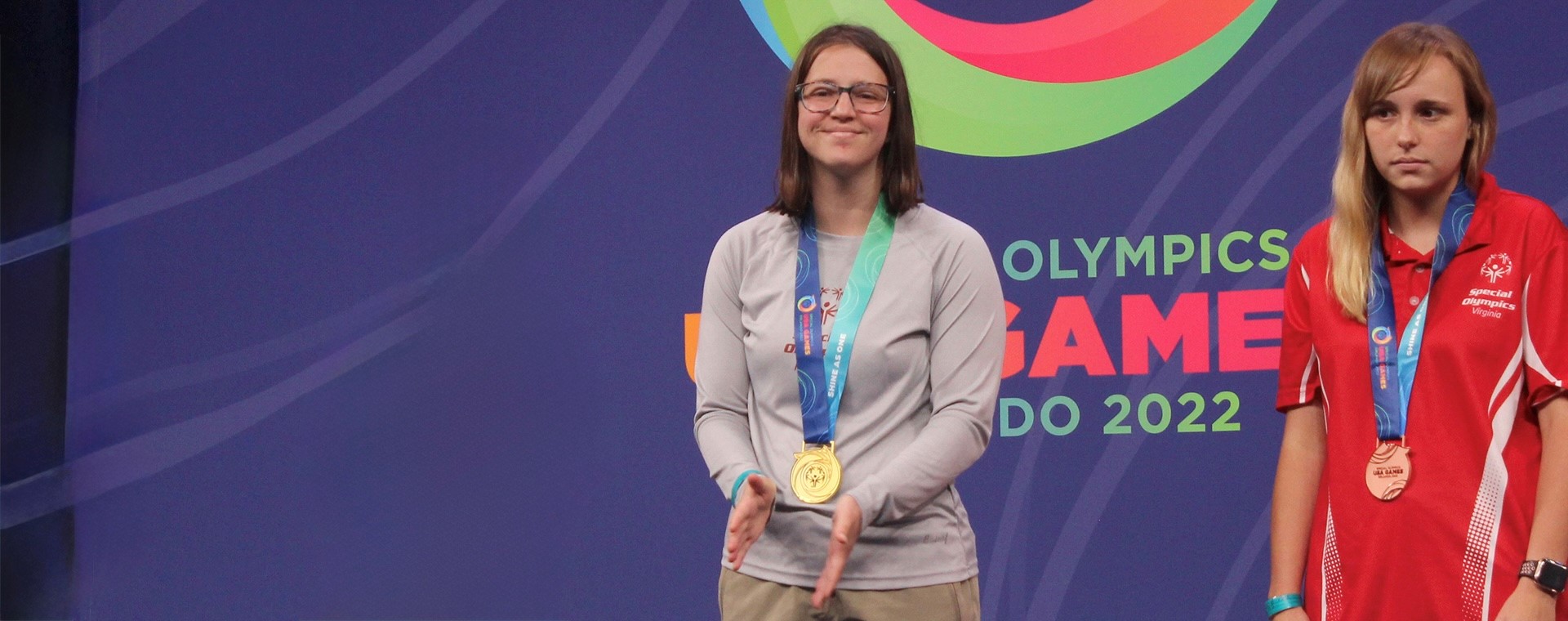 Maddie Brinkman on award stand with gold medal at 2022 USA Games