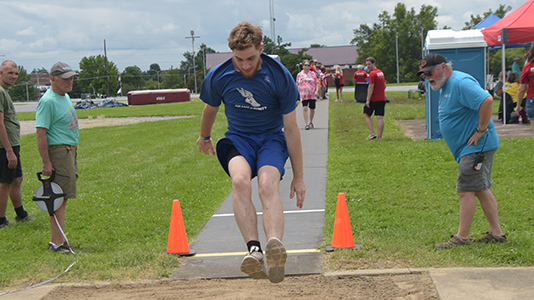 A Grant County athlete completes his long jump at the State Summer Games.