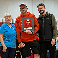 Kim Satterwhite and Brennan Smith present the Golisano Award to Jeff Corder.