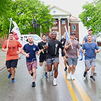 Law Enforcement Officers run with the Special Olympics Torch.
