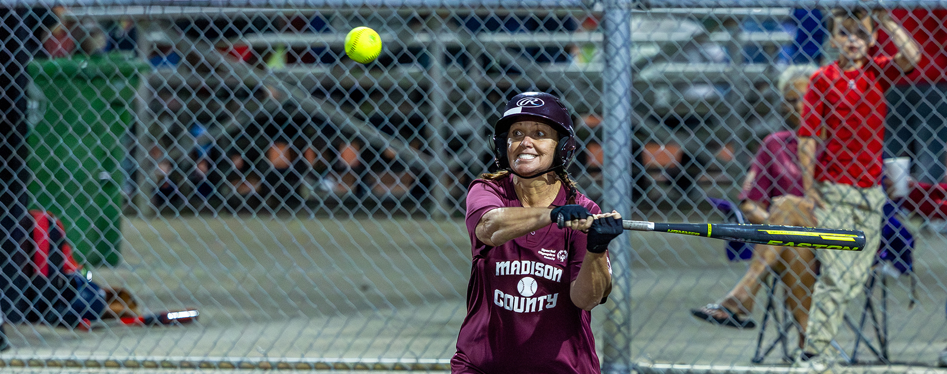 Athlete eyes a pitch as they swing at the 2025 State Softball Tournament.
