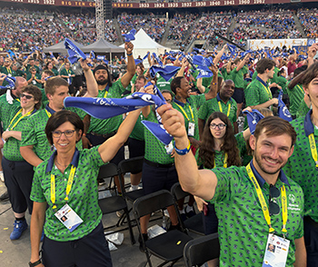 Coaches and athletes waving towels at the USA Games.
