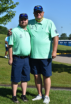 Two golfers standing side by side.