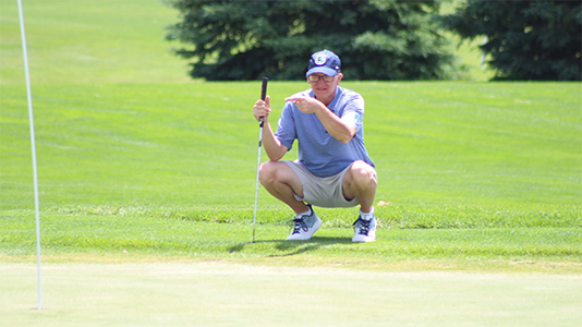 Chris Revay lines up a putt.