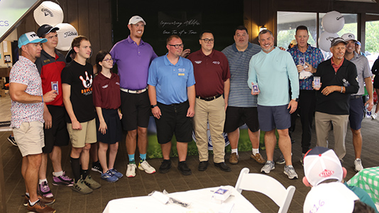 Athletes with golfers at the 2025 Texas Roadhouse Armadillo Classic.