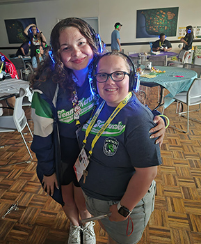 Mya Hetler and Olivia Pruitt with headphones on.