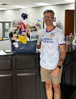Doug Webb at the SOKY office next to his Disney Gift Basket.